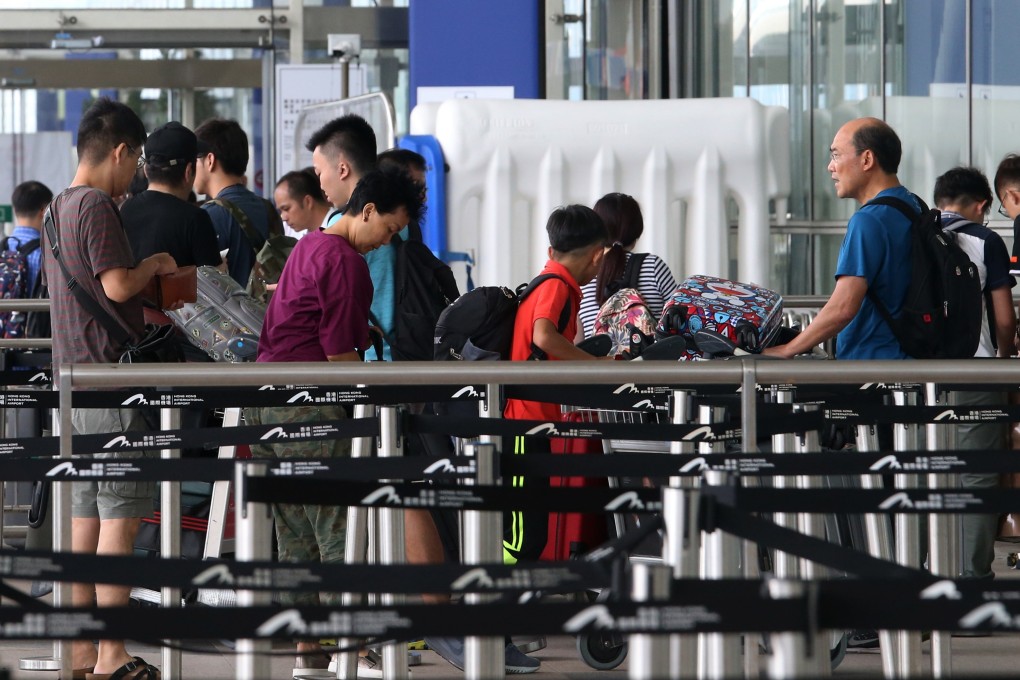 Travellers queue up to enter Hong Kong International Airport. Security measures have been strengthened to prevent anti-government protesters from occupying the airport again. Photo: David Wong