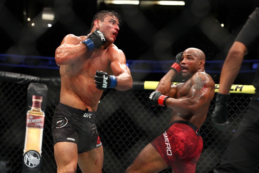 Paulo Costa throws a punch at Yoel Romero in the third round. Photos: AFP