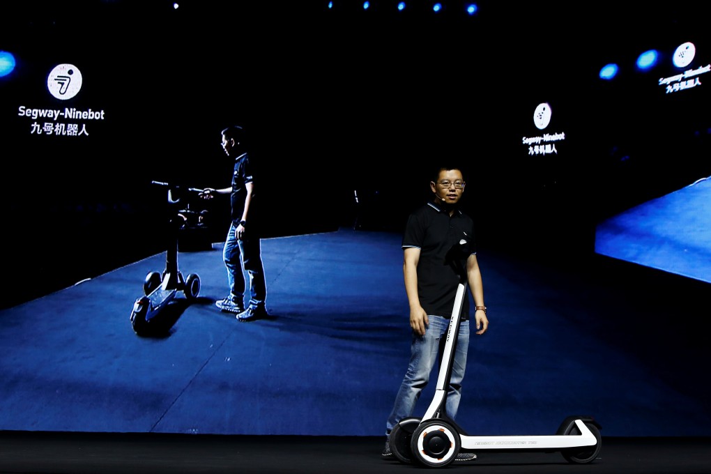 Ninebot President Wang Ye unveils semi-autonomous scooter KickScooter T60 that can return itself to charging stations without a driver, at a Segway-Ninebot product launch event in Beijing, China August 16, 2019. REUTERS/Florence Lo