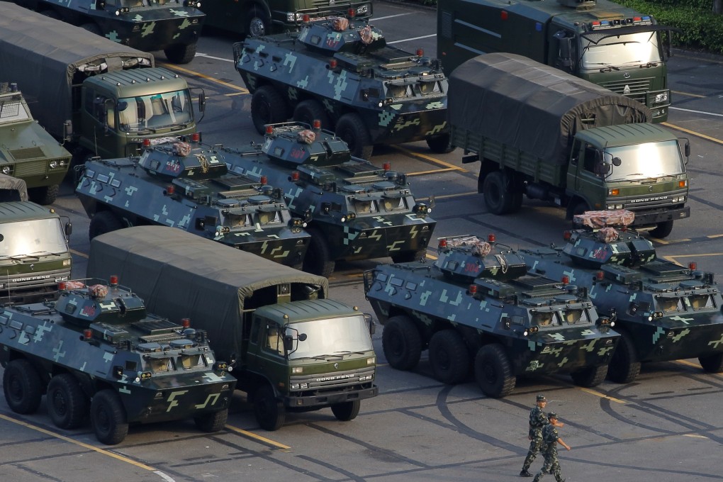 Military vehicles parked on the grounds of the Shenzhen Bay Sports Centre in Shenzhen. Photo: Reuters