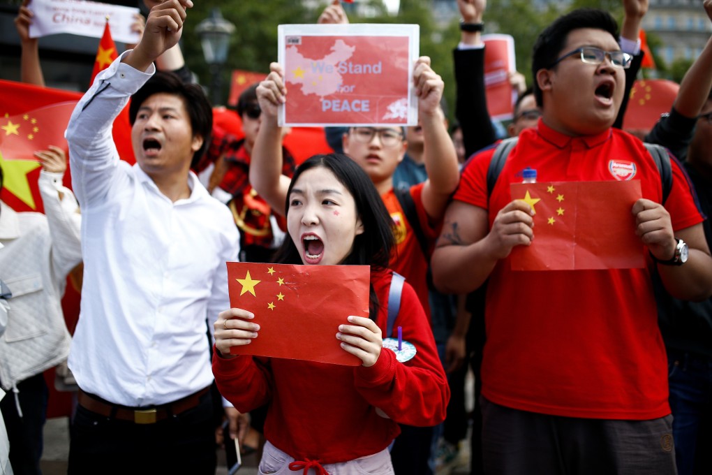 Demonstrators in support of the Chinese government gesture towards demonstrators supporting Hong Kong protestors, in central London. Photo: Reuters