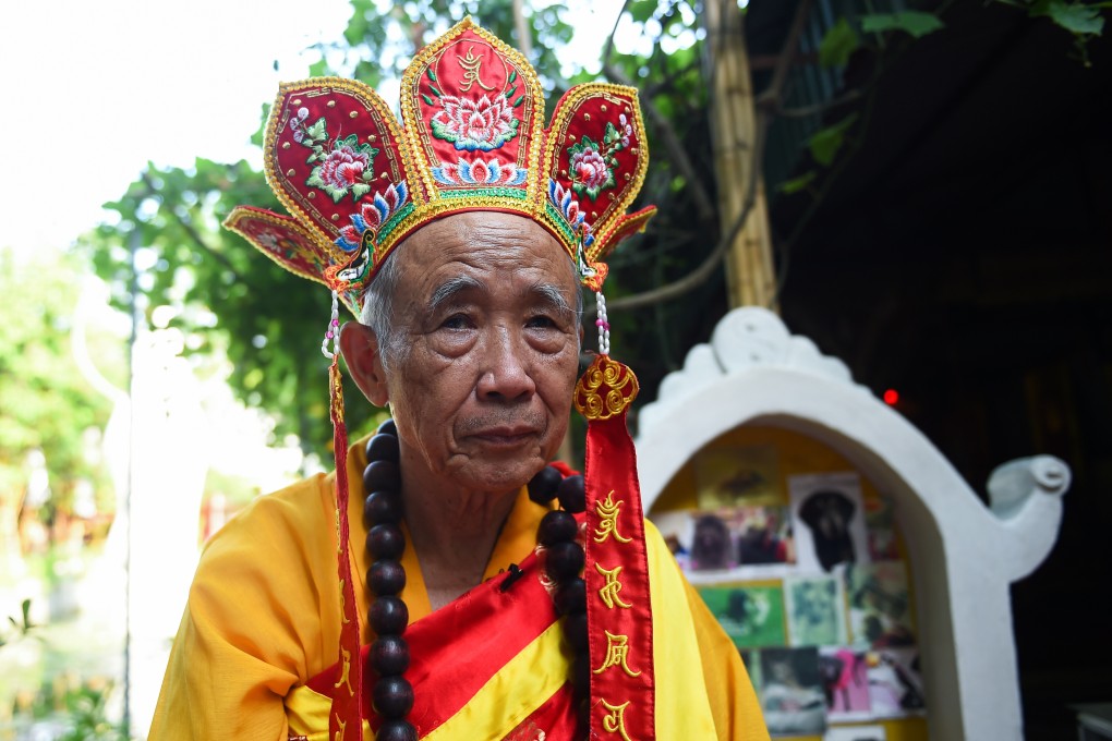 Nguyen Bao Sinh, the owner of a cemetery for pets, prepares for a prayer ceremony for dogs and cats at Te Dong Vat Nga pagoda in Hanoi, Vietnam. Photo: Nhac Nguyen/AFP