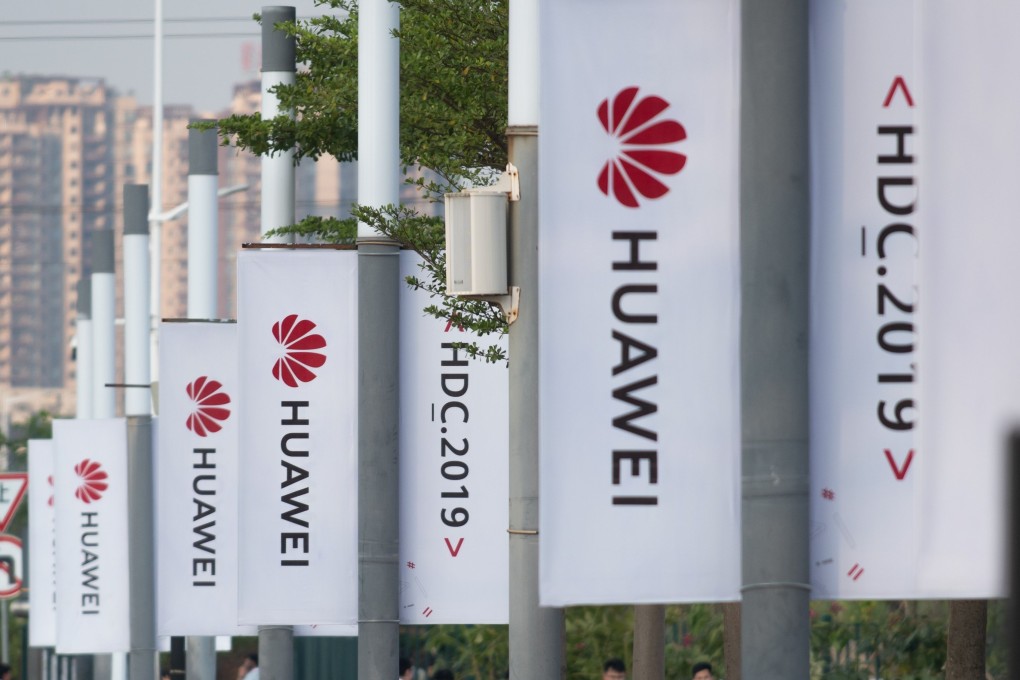 Banners with the Huawei logo are seen outside the venue where the telecoms giant unveiled its new HarmonyOS operating system in Dongguan, Guangdong province on August 9, 2019. Photo: AFP