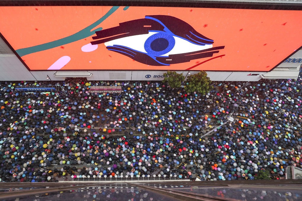 Protesters stream past Sogo department store in Causeway Bay. Photo: Robert Ng