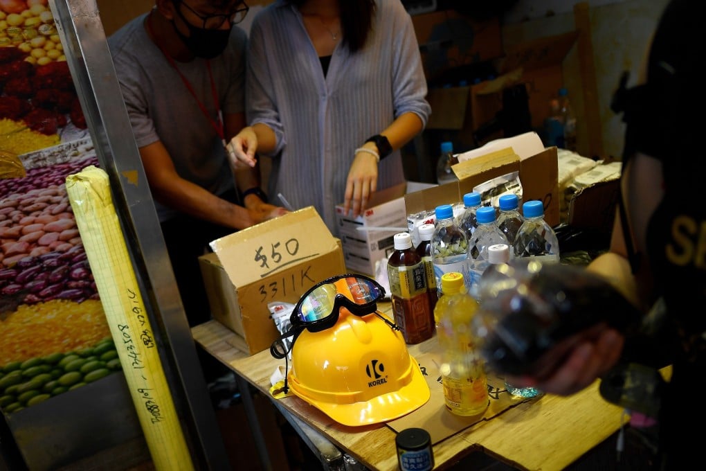 Pro-democracy protesters buying gas masks and other protective gear at the ‘National Calamity Hardware’ pop-up store in Tai Po, Hong Kong. Photo: AFP