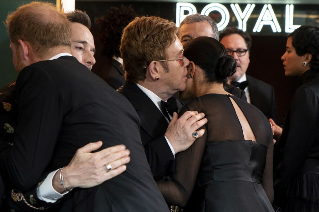 Britain's Prince Harry, Duke of Sussex, greets Canadian producer David Furnish as British singer-songwriter Elton John speaks with Britain's Meghan, Duchess of Sussex. Photo: Reuters