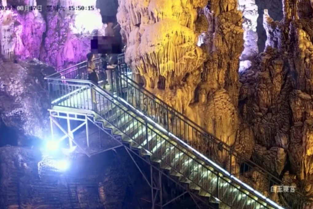 Security cameras caught a tourist at Tai Qing cave in Yuanan, Hubei province, as he snapped a stalactite and passed bits to his friends. Photo: Weibo