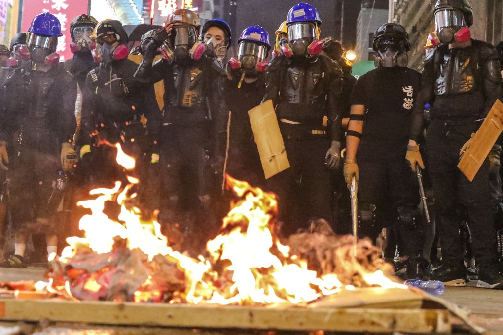Anti-government protesters set things on fire to obstruct Nathan Road in Mong Kok. Photo: Felix Wong