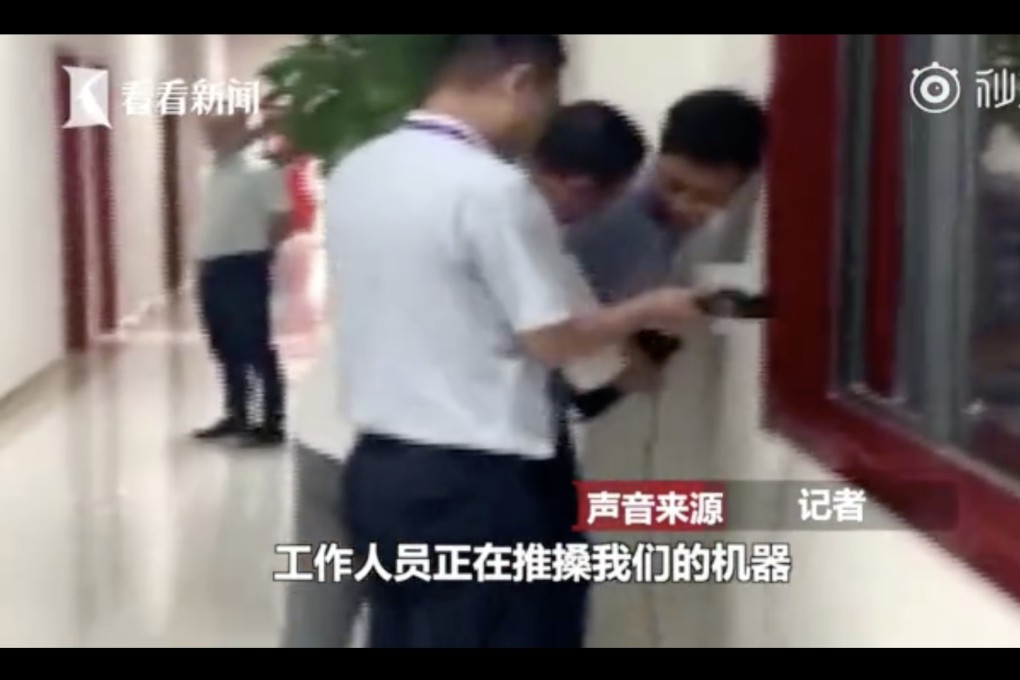 Staff at a hospital in central China confront a reporter from the local television station investigating claims that hospital staff have a “sales target” of five inpatient admissions, with a penalty if they fail to meet it. Photo: Weibo