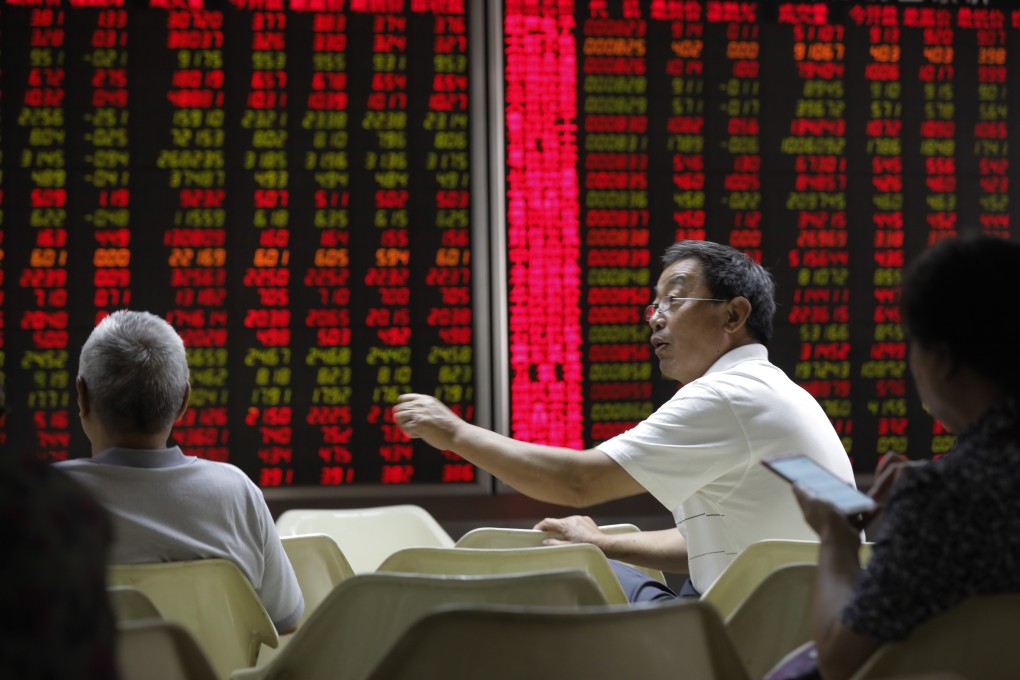 Chinese investors in front of an electronic board showing stock prices at a securities brokerage house in Beijing on 13 June 2019. Contrary to global conventions, China’s stock market represent gains and advances in red, using green to denote losses and declines. Photo: EPA-EFE