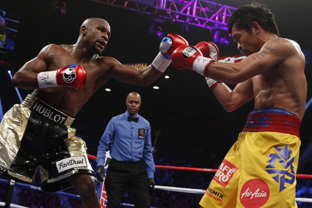 Floyd Mayweather Jnr exchanges punches with Manny Pacquiao at the MGM Grand Garden Arena in Las Vegas in 2015. Photo: AFP