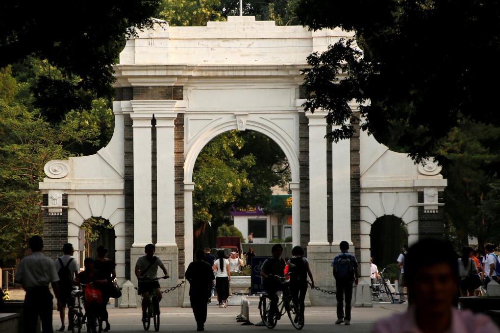 People walk near the gate of Tsinghua University in Beijing. Photo: Reuters
