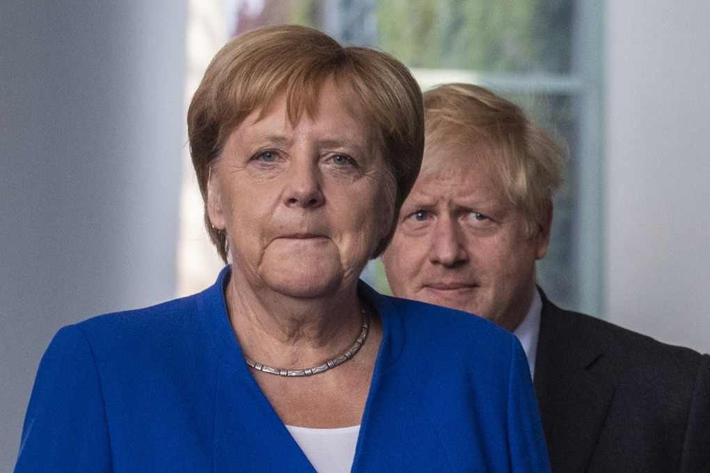 German Chancellor Angela Merkel and British Prime Minister Boris Johnson arrive for a press conference at the chancellery in Berlin on Wednesday. Photo: AFP