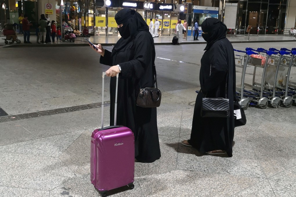 Saudi women walk with their luggage at King Fahd International Airport in Dammam. Photo: Reuters