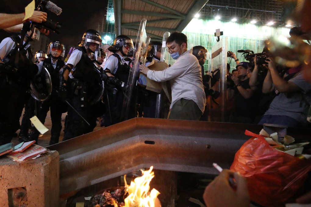 Riot police clash with protesters in Sham Shui Po, on August 14. Photo: Winson Wong
