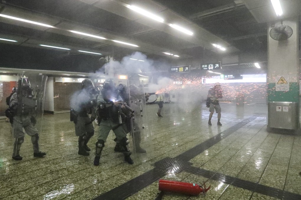 Riot police fire tear gas in Kwai Fong MTR station. Photo: Felix Wong