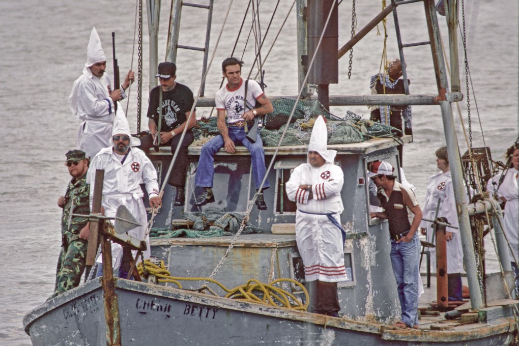 Ku Klux Klan members stage a protest on the Houston Ship Channel, in Texas, against the presence of Vietnamese fishermen in Galveston Bay, on March 15, 1981. Photo: John R. Van Beekum