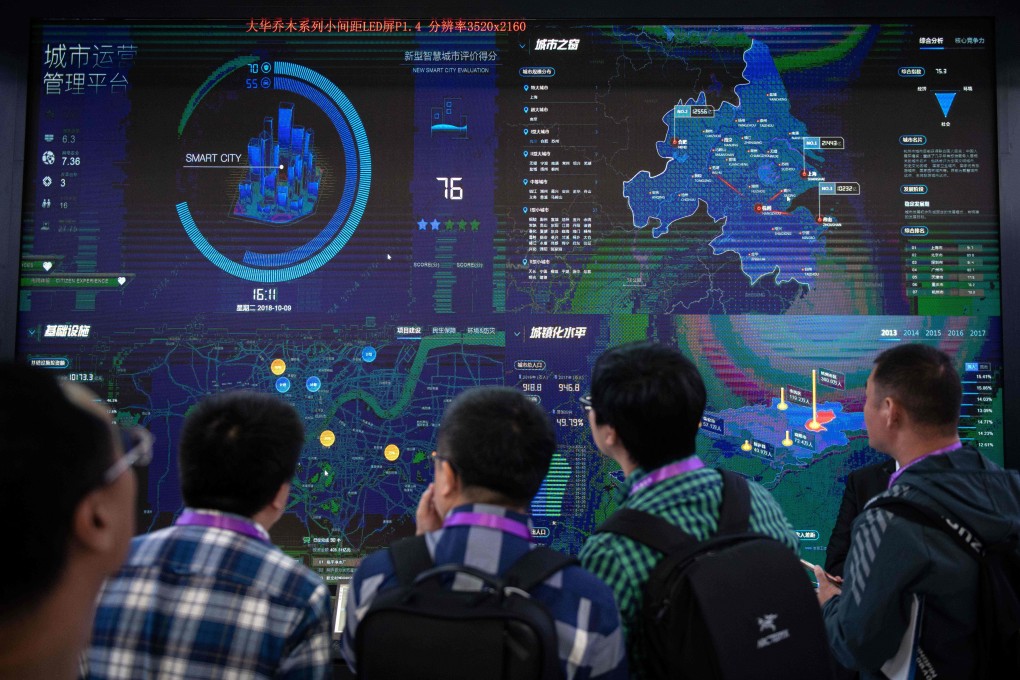 Visitors look at an AI security software program on a screen at the 14th China International Exhibition on Public Safety and Security at the China International Exhibition Center in Beijing on October 24, 2018. Photo: AFP
