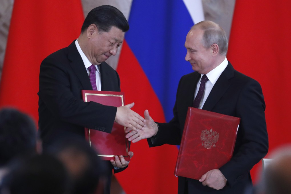 Chinese President Xi Jinping and Russian President Vladimir Putin shake hands during a signing ceremony after their talks at the Kremlin in Moscow on June 5. Photo: EPA-EFE