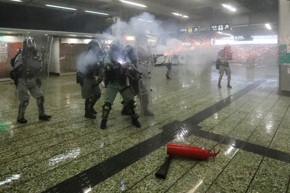 Riot police fire tear gas inside Kwai Fong MTR station during clashes with anti-government protesters. Photo: Felix Wong