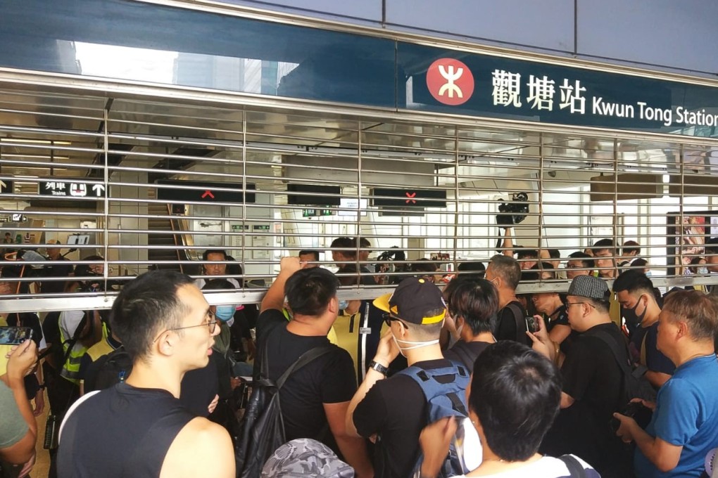 A crowd outside Kwun Tong station as workers try to shut down the place. Photo: Linda Lew