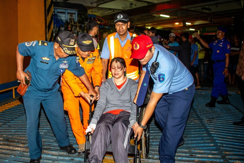 A passenger from the ferry that caught fire arrives at Tangjung Perak seaport in Surabaya, East Java, on Friday. Photo: AFP