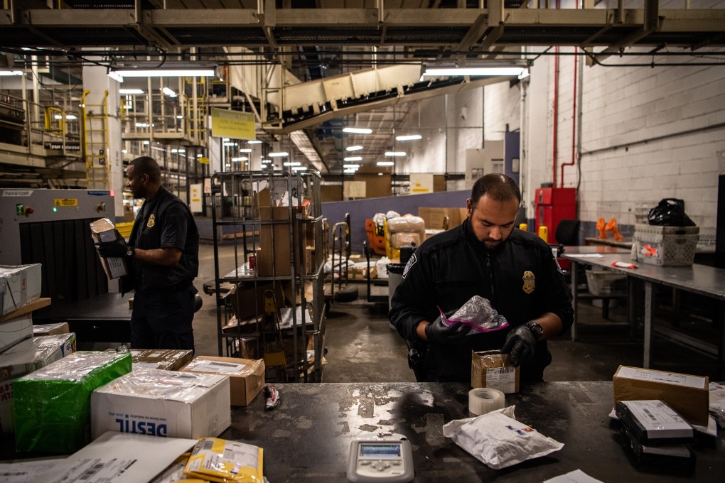 US customs officials inspect a package of fentanyl intercepted at John F Kennedy airport in New York. Photo: Washington Post