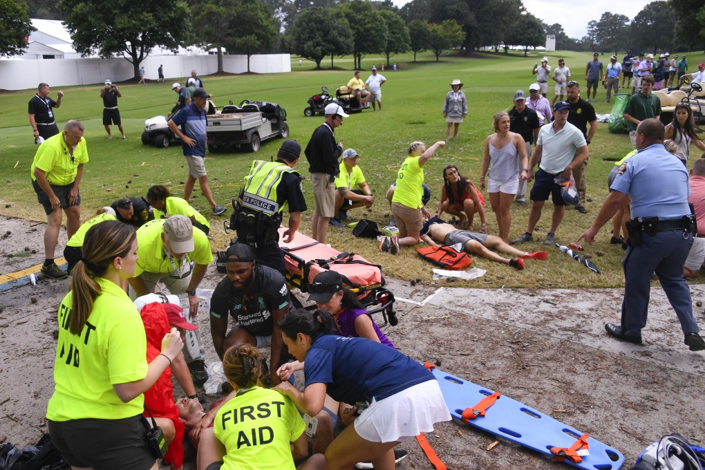 Spectators are tended to after a lightning strike on the East Lake Golf Club course. Photo: AP Photo