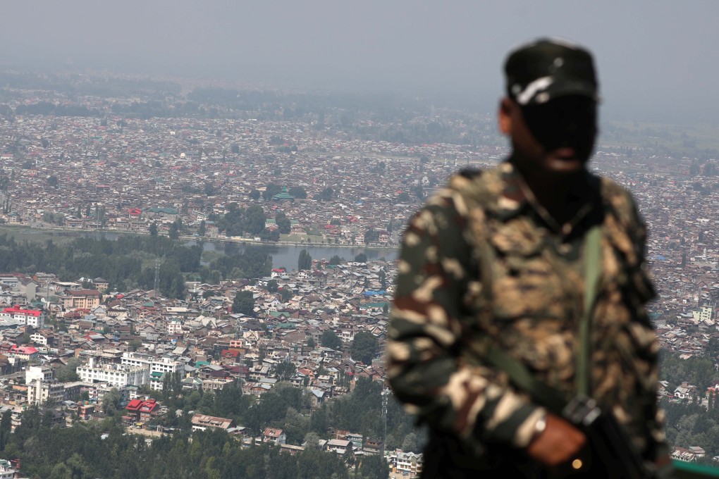 An Indian paramilitary soldier keeps watch from the top of a hill in Srinagar. Photo: EPA