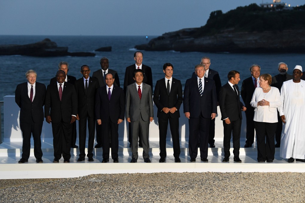 G7 leaders pose for a family photo with invited guests during the summit in Biarritz. Photo: Pool via Reuters