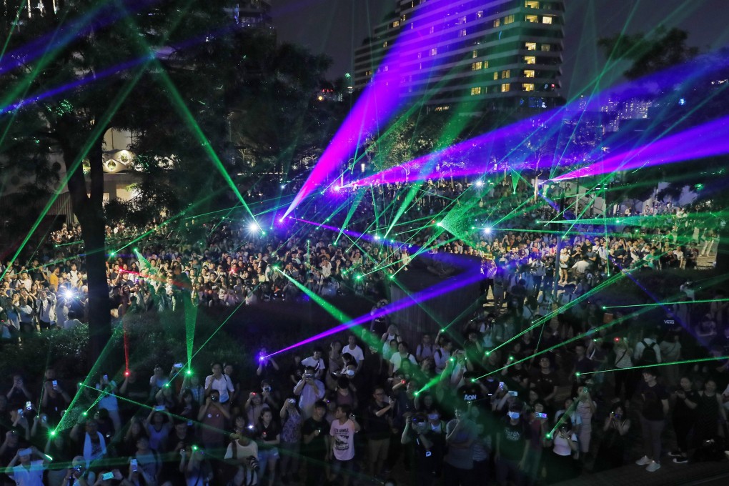 Laser pointers are used during a rally to demonstrate against the arrest of people caught in possession of such gadgets. Photo: AP