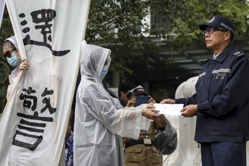 The masked demonstrators said they were family members of police officers who felt unfairly trapped between the government and protesters. Photo: Nora Tam