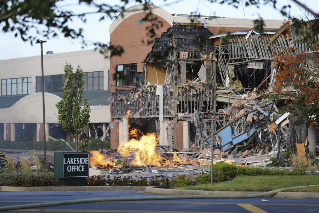 The scene of a damaged building and burning debris nearby after an explosion at an office complex and shopping center in Columbia. Photo: Howard County Fire And Rescue via AP