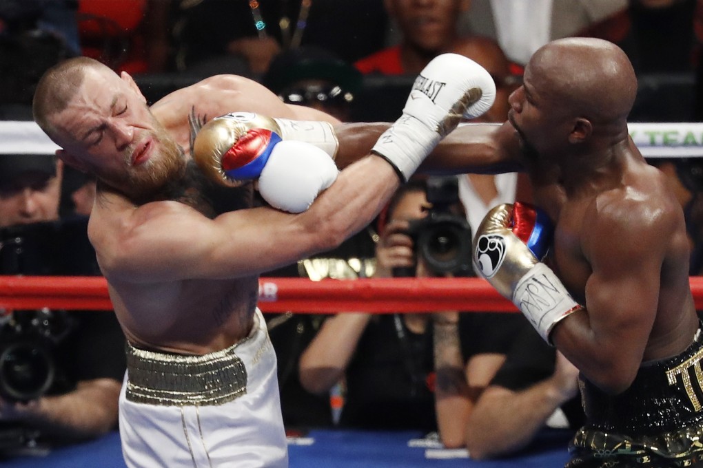 Floyd Mayweather Jnr hits Conor McGregor during their super welterweight boxing match in Las Vegas in 2017. Photo: AP