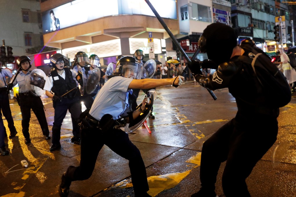 Police and protesters clash in Tsuen Wan on Sunday. Photo: Reuters