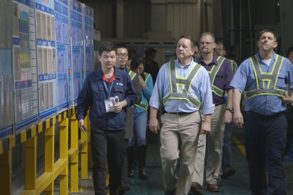 American Fuyao management team members and others tour a Fuyao plant in Fuqing, Fujian province in “American Factory”. Photo: Netflix via AP