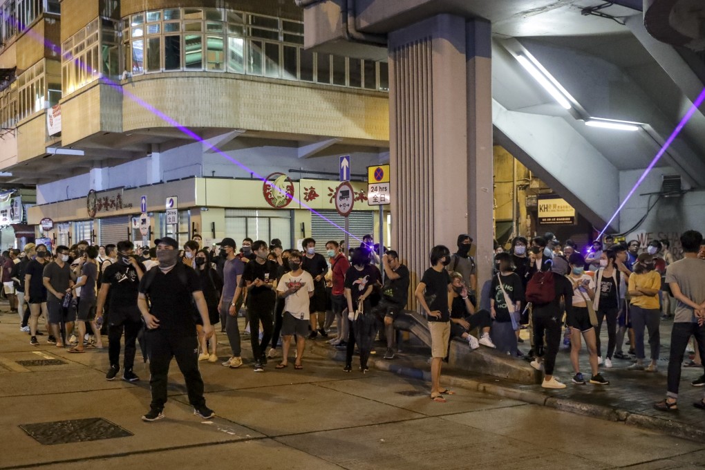 Protesters point laser beams in Sham Shui Po. Photo: Edmond So