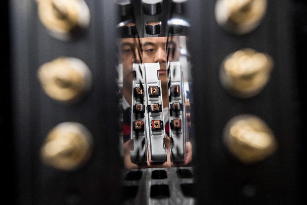 An employee installs a lithium-ion battery cell into a testing system at the offices of Powervault, a company helping to recycle lithium-ion car and bus batteries in London. Photo: Bloomberg