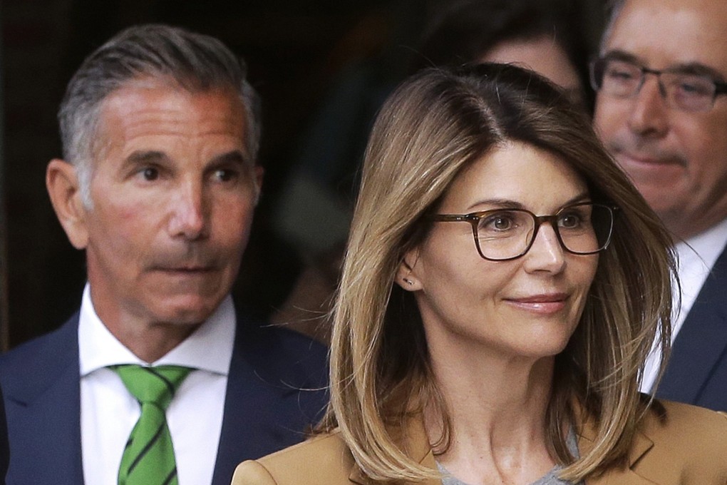 Actress Lori Loughlin, front, and husband, clothing designer Mossimo Giannulli, left, leave federal court in Boston. Photo: AP Photo