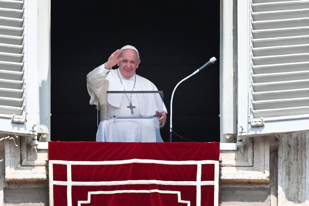 Pope Francis waves to worshipers as he speaks from the window of the apostolic palace overlooking St. Peter’s Square. Photo: AFP