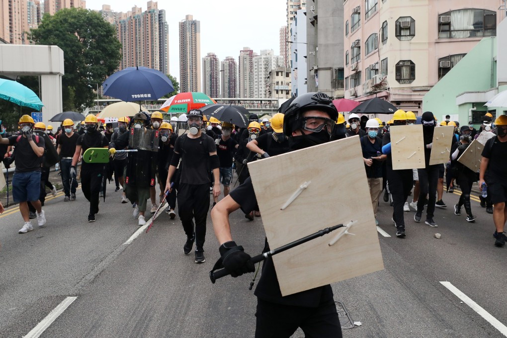 Protesters take to the streets in Yuen Long on July 21. The sight of black-clad protesters with makeshift weapons and defences clashing with police has become commonplace in Hong Kong. Photo: Sam Tsang