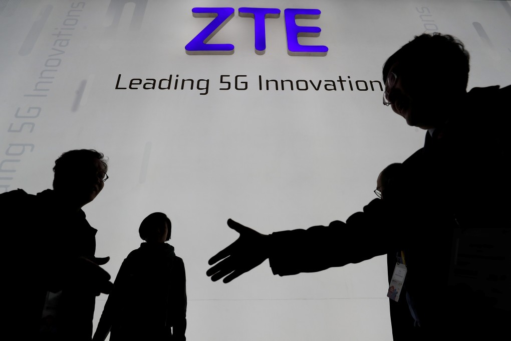 Visitors pass in front of ZTE Corp’s booth at the MWC Barcelona trade show held in February this year. Photo: Reuters