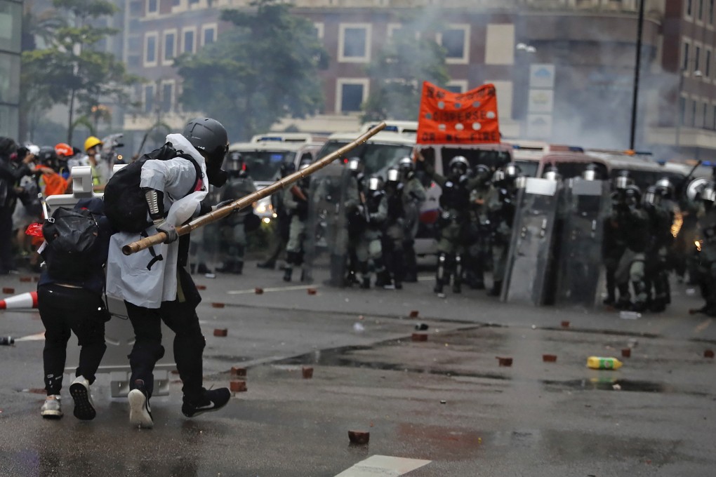 Protesters use bamboo sticks as they face riot police during a protest in Hong Kong. Photo: AP