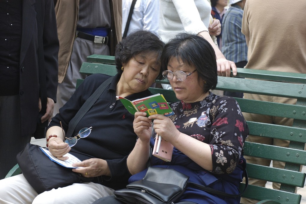 Mothers exchange details of prospective partners for their unmarried children at a matchmakers’ meeting in Beijing’s Zhongshan Park. Photo: Miriam Clifford