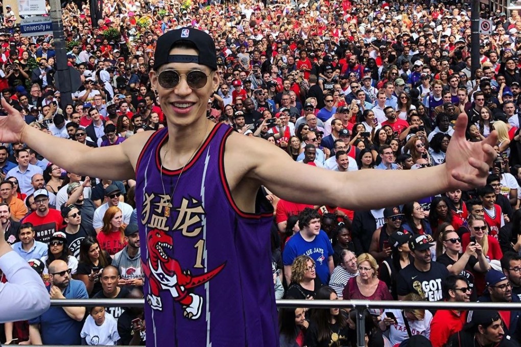 Jeremy Lin in his retro Toronto Raptors jersey on top of their bus for the parade to celebrate their NBA Finals win. Photo: Instagram/@JLin7