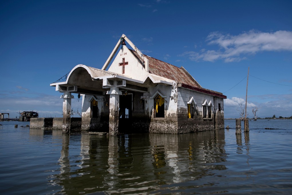 A chapel is seen amid encroaching bay waters in Sitio Pariahan, Bulacan, Philippines. Photo: AFP