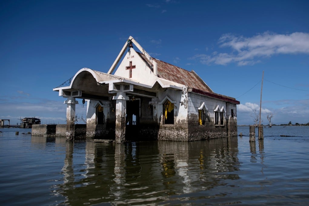 A chapel is seen amid encroaching bay waters in Sitio Pariahan, Bulacan, Philippines. Photo: AFP
