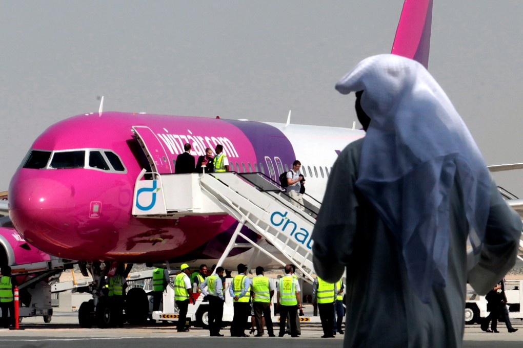 Passengers leave an aircraft at the newly opened Al Maktoum International Airport in Dubai in October 2013. Photo: AP