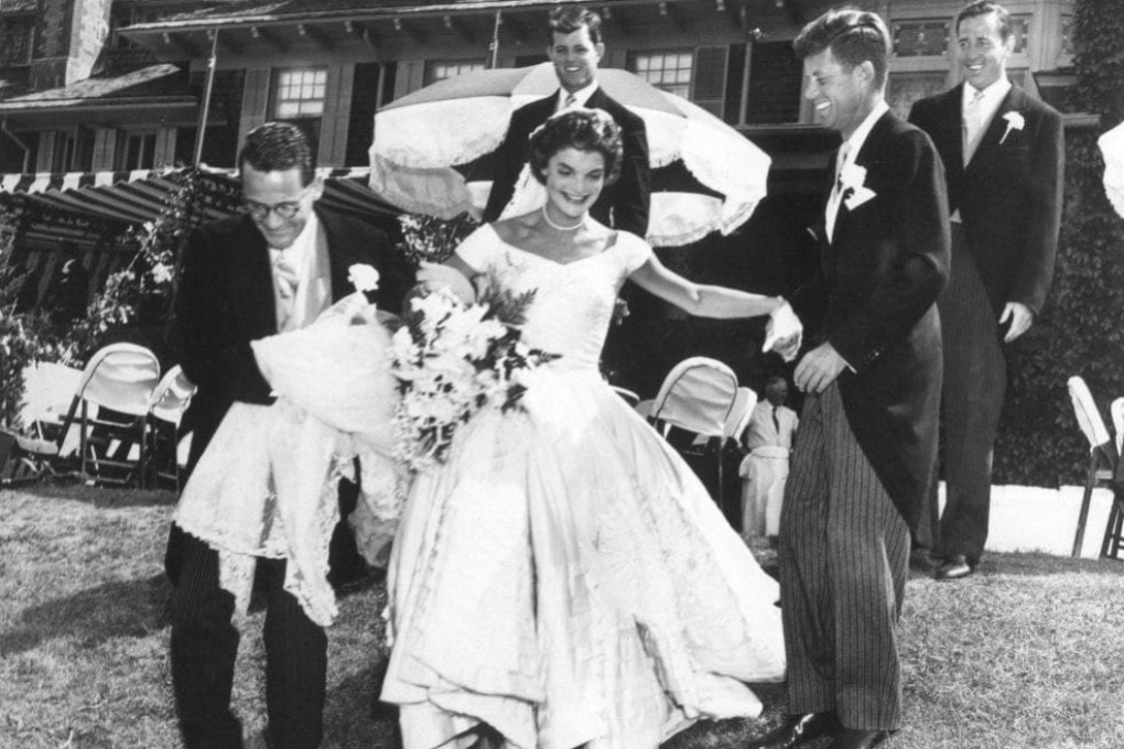 Jackie Kennedy in the wedding gown designed by Ann Lowe on September 12, 1953. Groom John F. Kennedy is second from right. Photo: Toni Frisell / John F. Kennedy Presidential Library and Museum