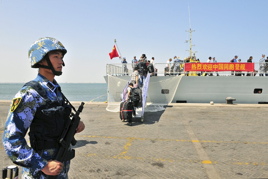 A soldier of the People’s Liberation Army stands guard as Chinese citizens board a navy ship in Aden in 2015. Photo: Reuters